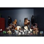 A collection of figurines in various mediums including Beswick, carved wood and bone