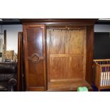 An early 20th Century mahogany mirror door triple wardrobe