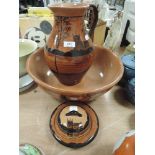 A large terracotta and hand decorated wash jug and bowl set