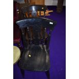 A pair of traditional dark stained solid seat kitchen chairs