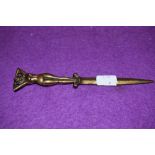 A brass letter opener with an artistic young lady handle