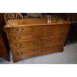 A reproduction light mahogany bedding box modelled as chest of three over 6 drawers