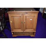 A pine wall cabinet with shelf under