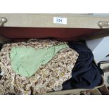 A small vintage suitcase containing a collection of ladies vintage and retro blouses . Great