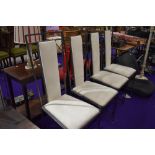 A set of four modern metal dining chairs