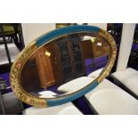A vintage painted oval wall mirror