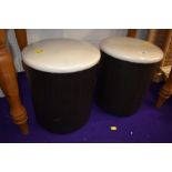 A pair of modern padded floor stools