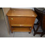 A vintage golden oak sewing trolley and contents