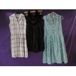 Two vintage 1950s dresses and one early 60s, a gingham shirtwaister and one with blue rose print and