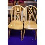 A pair of wheel back kitchen chairs