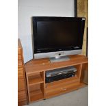 A Bush TV, laminate TV stand and other electronics