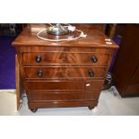 A 19th century mahogany commode formed as small chest of drawers, with lift top and fitted interior,