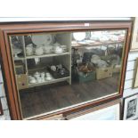 A wooden framed mantle mirror