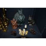 A selection of carved wooden figurines and teddy bear resin figures