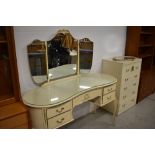 A vintage French style dressing table and narrow chest of drawers