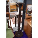 A traditional dark stained pedestal