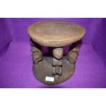 An African hand carved stand with fertility figures