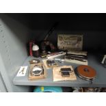 A selection of curios and trinkets including selection of pens lighter and letter head stamp