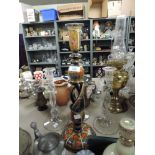 Three glass candlestick holders and another larger decorative painted wooden one.