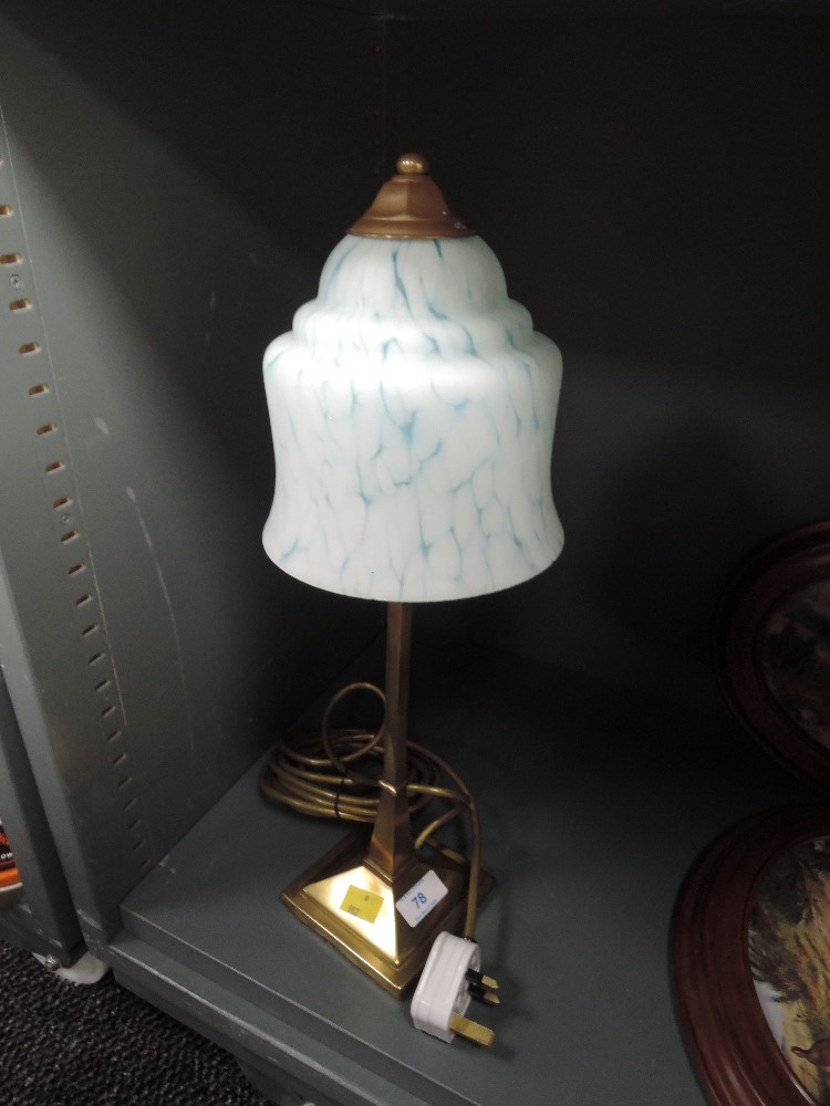 A solid bodied desktop lamp with mottled blue light shade