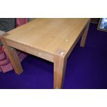 A modern part oak dining table