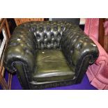 A green leather Chesterfield armchair