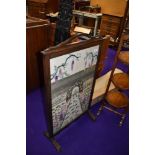 An early 20th Century oak framed embroidered fire screen