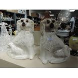 Two Staffordshire flat back mantel dogs having glass eyes. Good condition.
