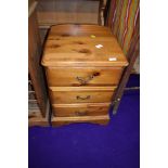 A pine three drawer bedside chest