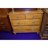 A traditional stained pine two over two chest of drawers