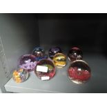 A selection of glass paper weights including Caithness