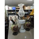 Two ceramic mantel urns and an oil lamp having fluted glass chimney.