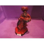 A Royal Doulton flambe figure, The Lamp Seller HN3278