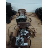 Four 35mm cameras, a Zeiss Icon Contina, a Zeiss Ikon Ikonta, a Kodak Retina automatic II, and a