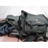 A selection of fishing bags and clothing including waders