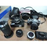An Olympus OM20 camera, a Fujicarex II camera, an Olympus XA camera, a Sun 80-200mm lens, Tokina