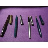 Four Parker fountain pens including two Parker 51's, a Duofold Junior and a Parker 65