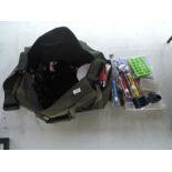 A bag containing a large selection of fishing tackle, most unused