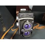 A Microcord twin lens reflex, 2-1/4 inch (6cm x 6cm) camera with Ross 77.5mm F3.2 lens, in