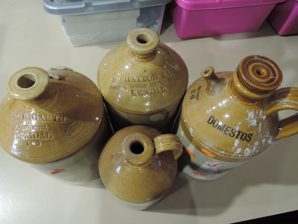 A vintage earthenware spouted advertising bottle for domestos and similar flagons for Hogarth and