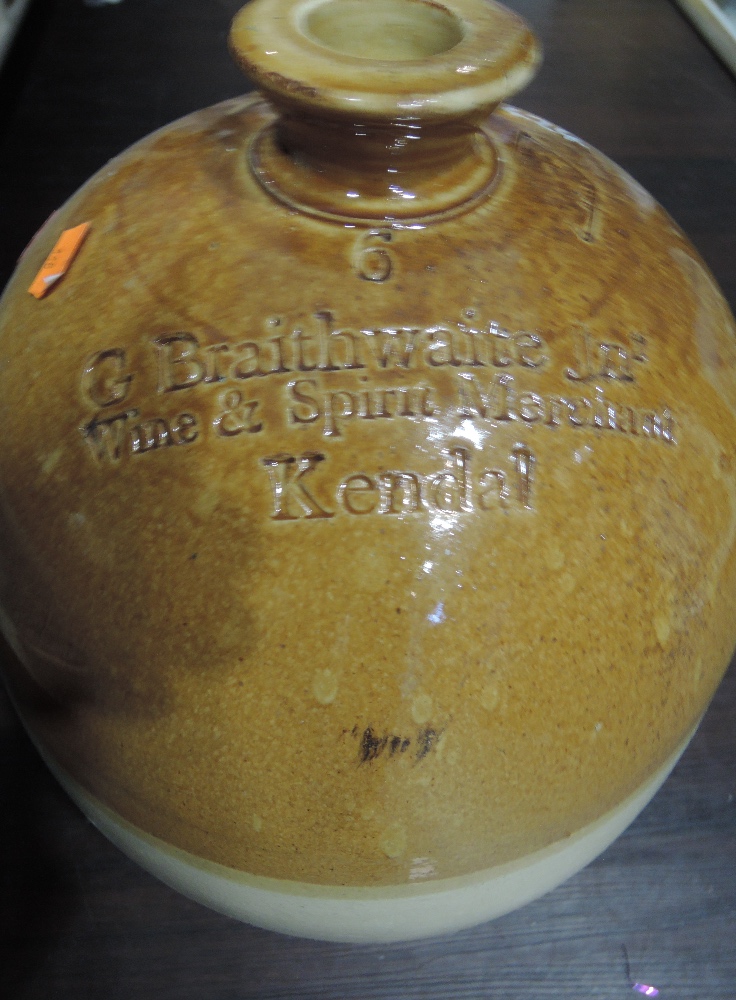 A large advertising flagon for G Braithwaite Wine and Spirit Merchants Kendal