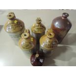 A selection of earthen ware advertising bottles and flagons including Heywood Botanic, George Gazey,