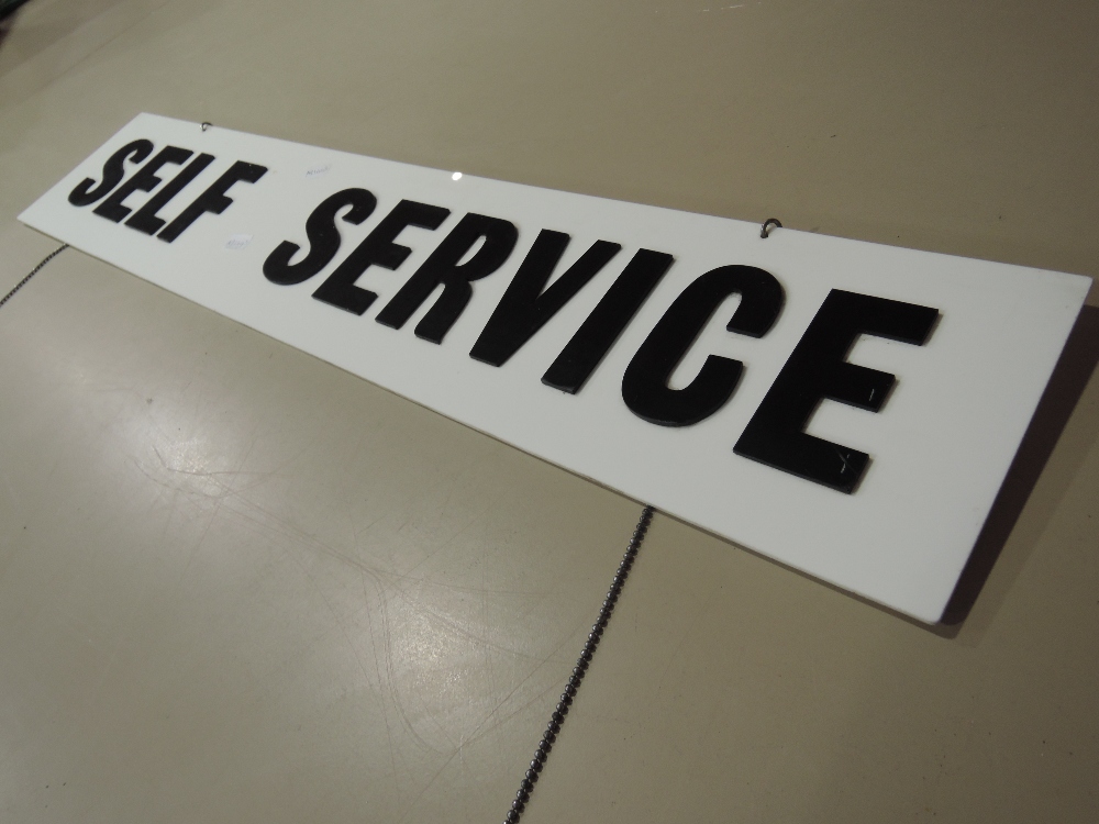 A vintage shop or factory sign with raised acrylic lettering reading Self Service