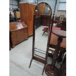 A 20th century mahogany period style cheval mirror of arch and finial design