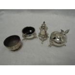 A silver three piece cruet having blue glass liners, trefoil hoof feet and gadrooned decoration,