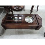 An early 20th century stained frame wall clock having circular silvered dial and bevelled glass