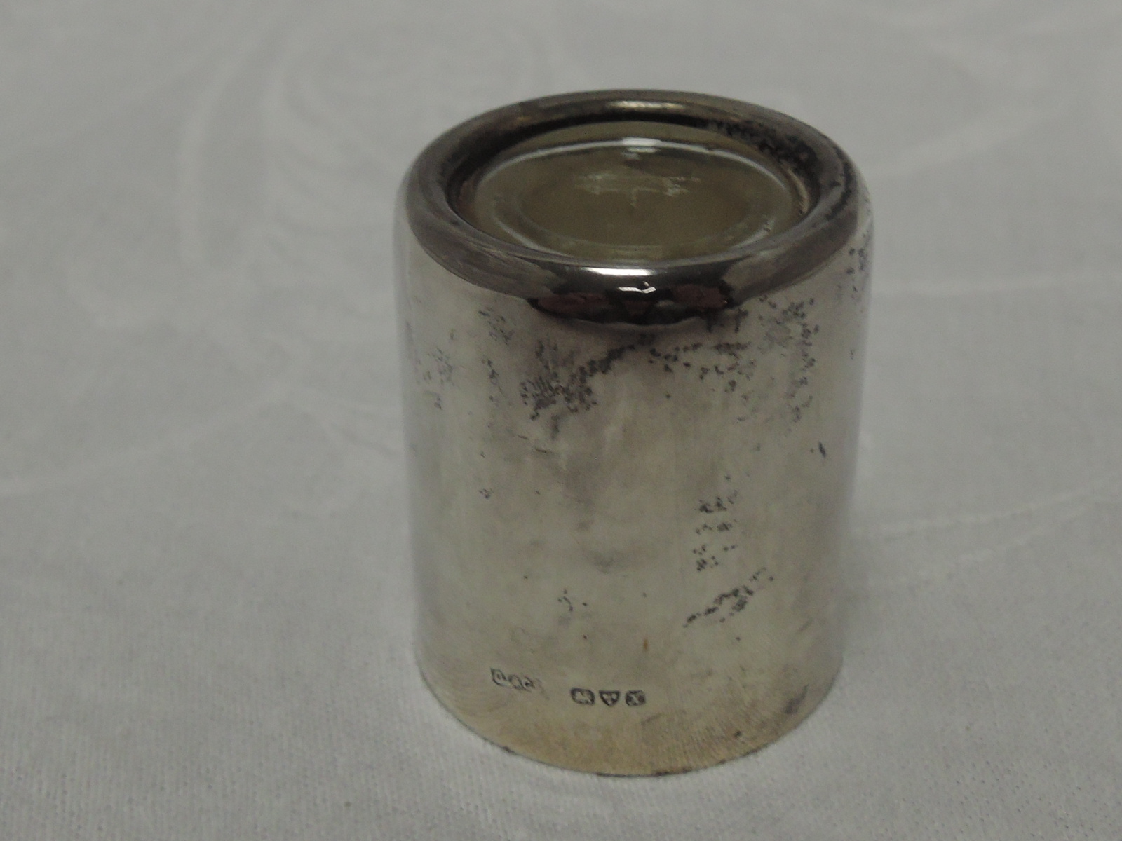 A silver inkwell of unspillable plain cylindrical form having clear glass liner, Chester 1910,