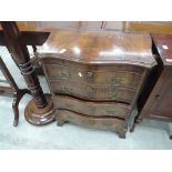 A 20th century mahogany period style serpentine front chest of four drawers on shaped feet