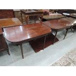 A 19th century mahogany dining table having D end top with one leaf, on turned and tapered legs