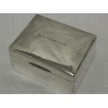 A silver cigarette box of plain form bearing presentation inscription to lid, Sheffield 1950, Walker